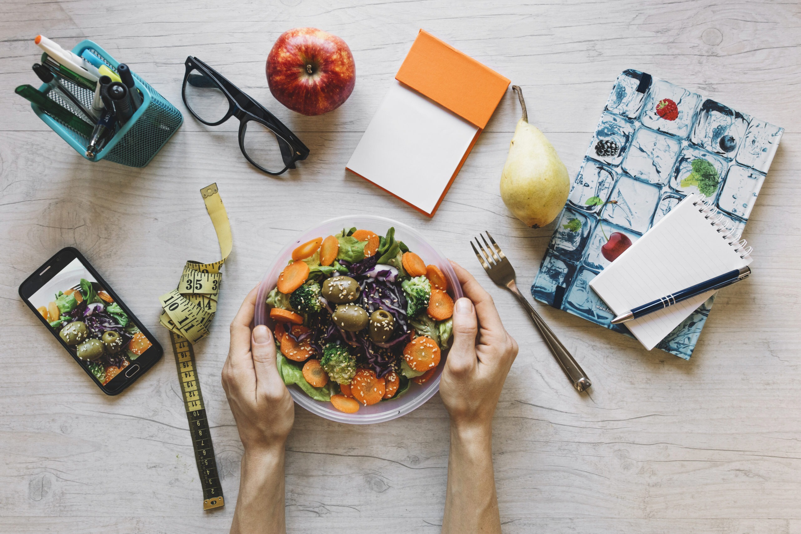 crop-hands-holding-bowl-with-salad-office